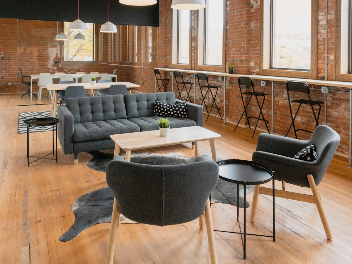 Furniture arranged in a brick-walled loft showroom
