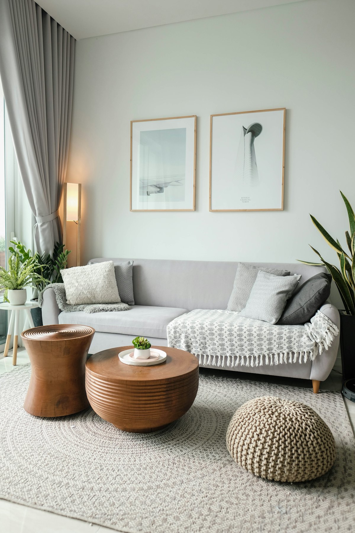 Hand-turned wooden coffee tables beside a linen sofa